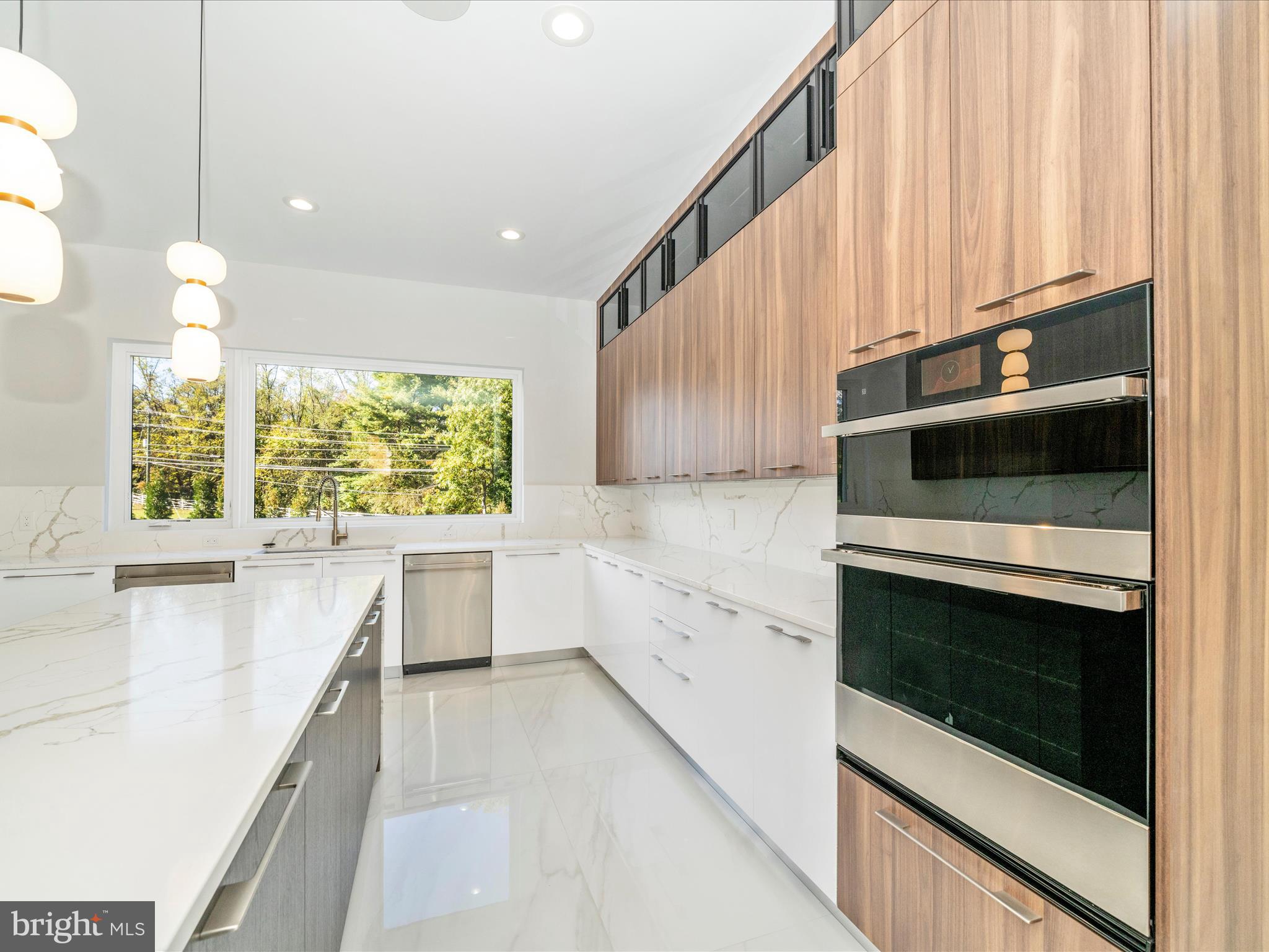 2209 Hunter Mill Road Vienna, VA 22181 - Photo 28 of 102 a kitchen with stainless steel appliances kitchen island granite countertop white cabinets and window