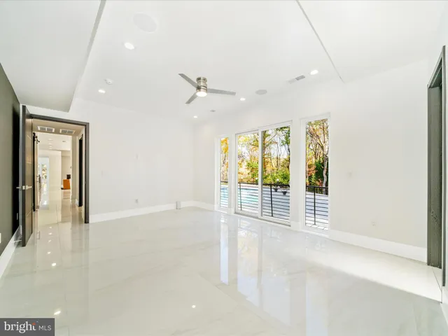 a view of a hallway with dining area and glass doors