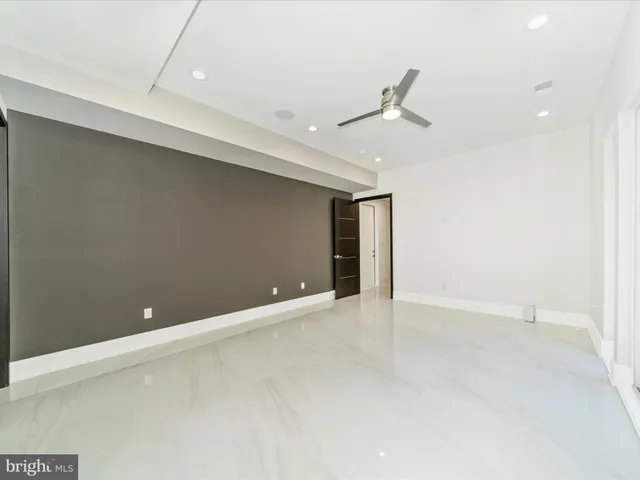 a kitchen with a sink cabinets and wooden floor