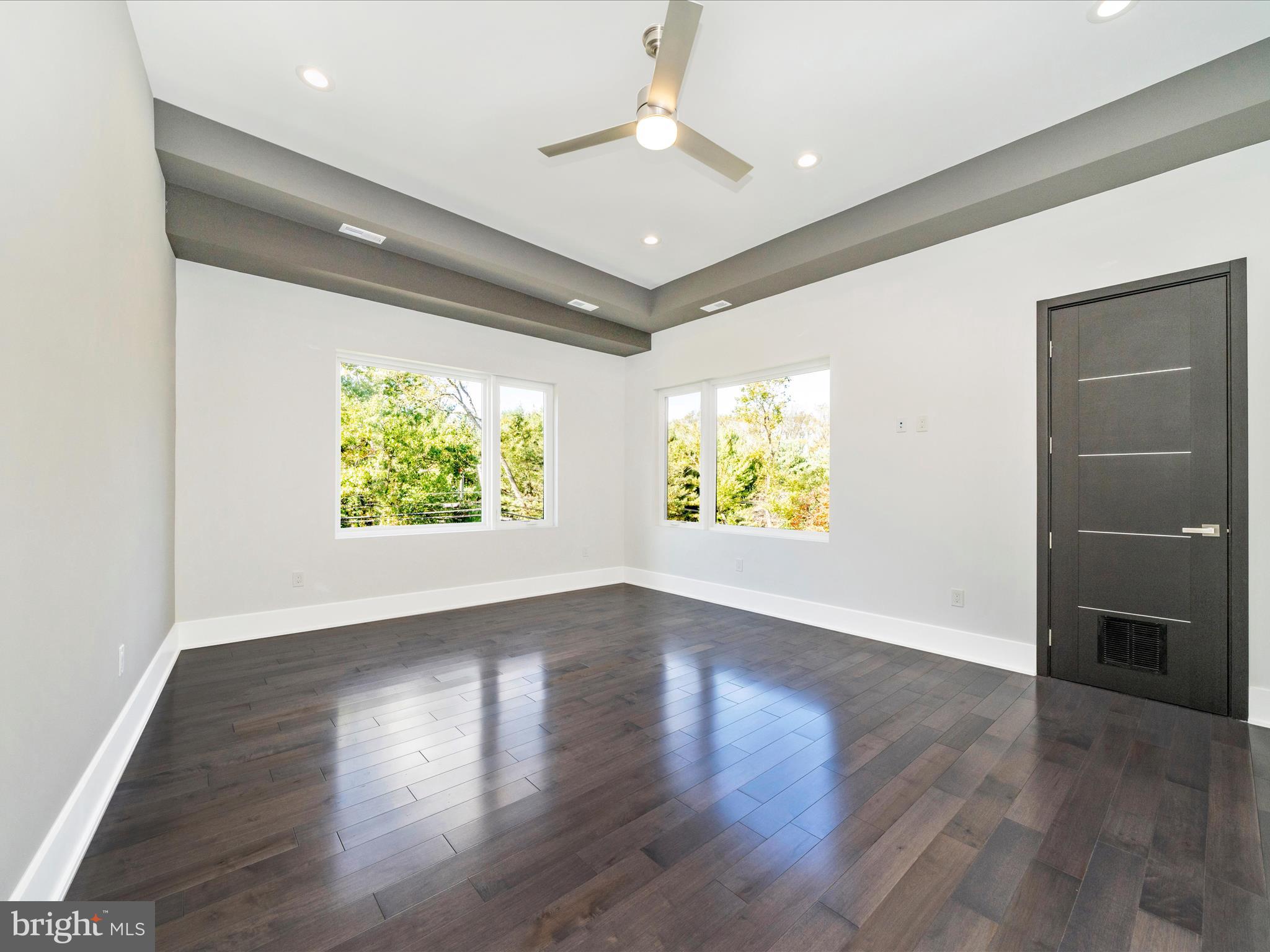 2209 Hunter Mill Road Vienna, VA 22181 - Photo 50 of 102 an empty room with wooden floor and windows