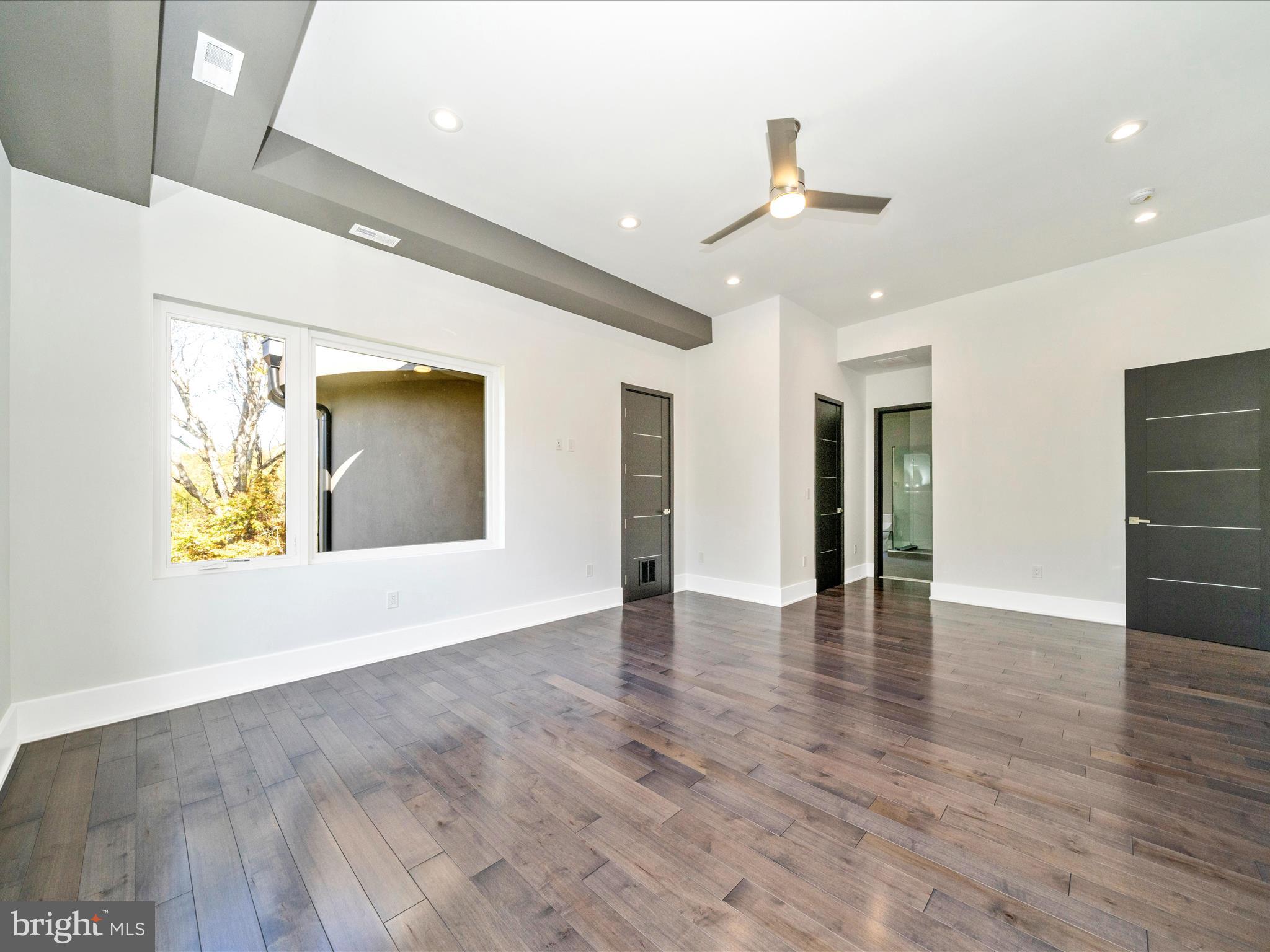 2209 Hunter Mill Road Vienna, VA 22181 - Photo 52 of 102 a view of an empty room with wooden floor and a window