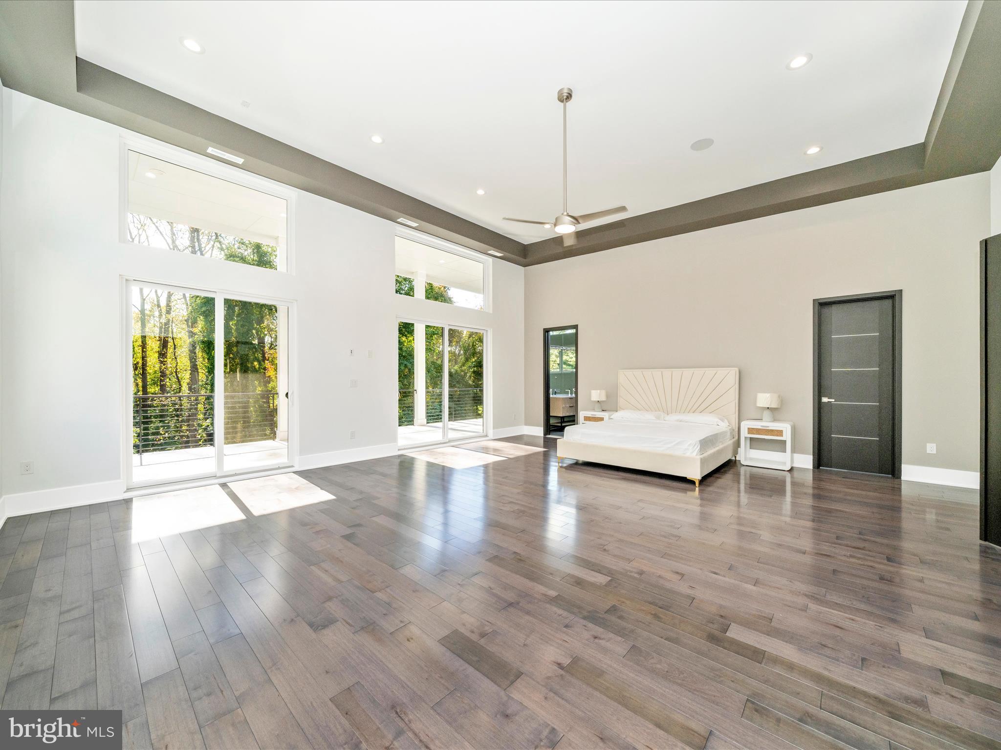 2209 Hunter Mill Road Vienna, VA 22181 - Photo 58 of 102 a view of an empty room with wooden floor and a window