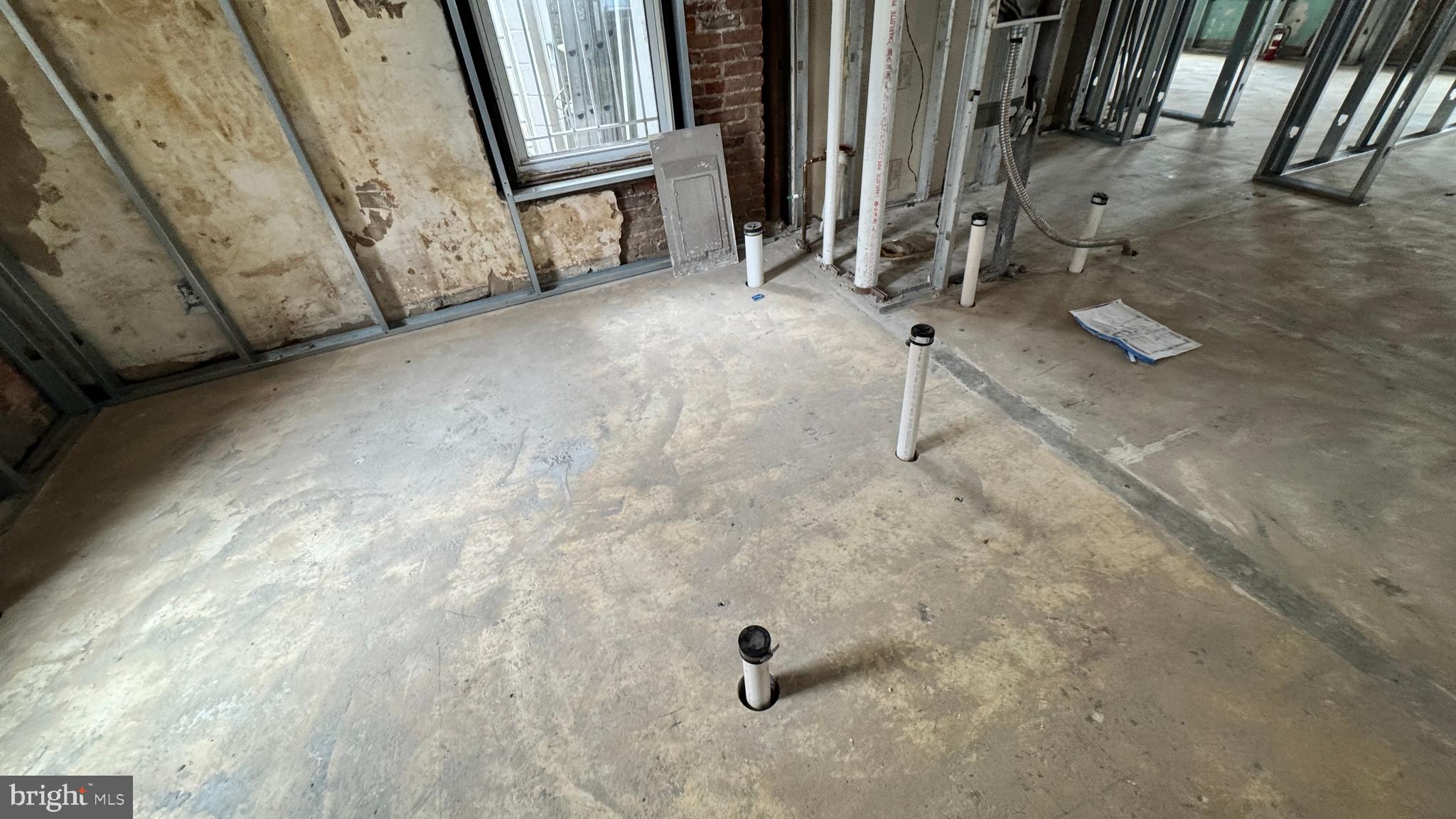 1745 Kalorama Road Northwest, Unit 101 Washington, DC 20009 - Photo 21 of 23 a view of a room with exposed pipes and a window