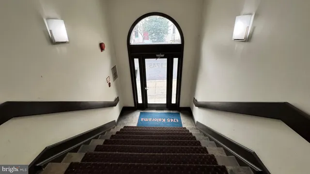 a hallway with a large window and wooden floor