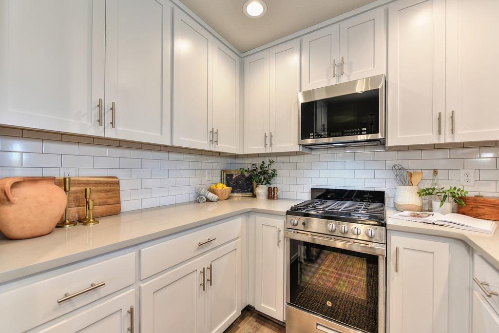2660 Commons Place Auburn, CA 95603 - Photo 21 of 55 a kitchen with granite countertop white cabinets stainless steel appliances and a sink