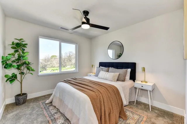 a kitchen with stainless steel appliances granite countertop a stove a sink dishwasher and a dining table with wooden floor