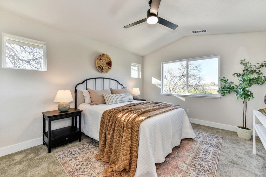 2660 Commons Place Auburn, CA 95603 - Photo 31 of 55 a bedroom with a bed and a painting on the wall