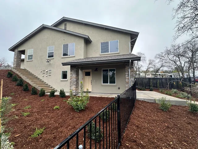 a living room with furniture kitchen view and a table