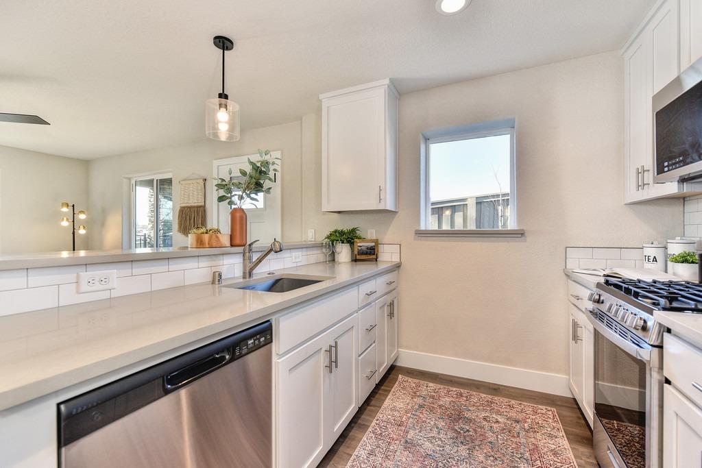 2660 Commons Place Auburn, CA 95603 - Photo 45 of 55 a kitchen with a sink stove and microwave