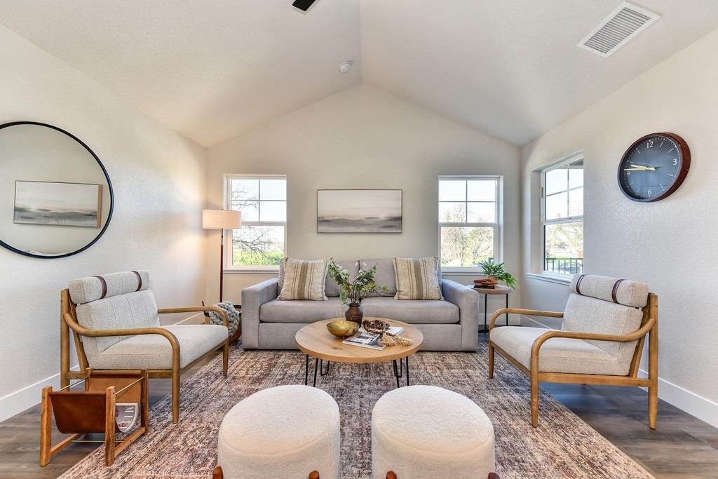 2660 Commons Place Auburn, CA 95603 - Photo 10 of 55 a living room with fireplace a mirror and a table
