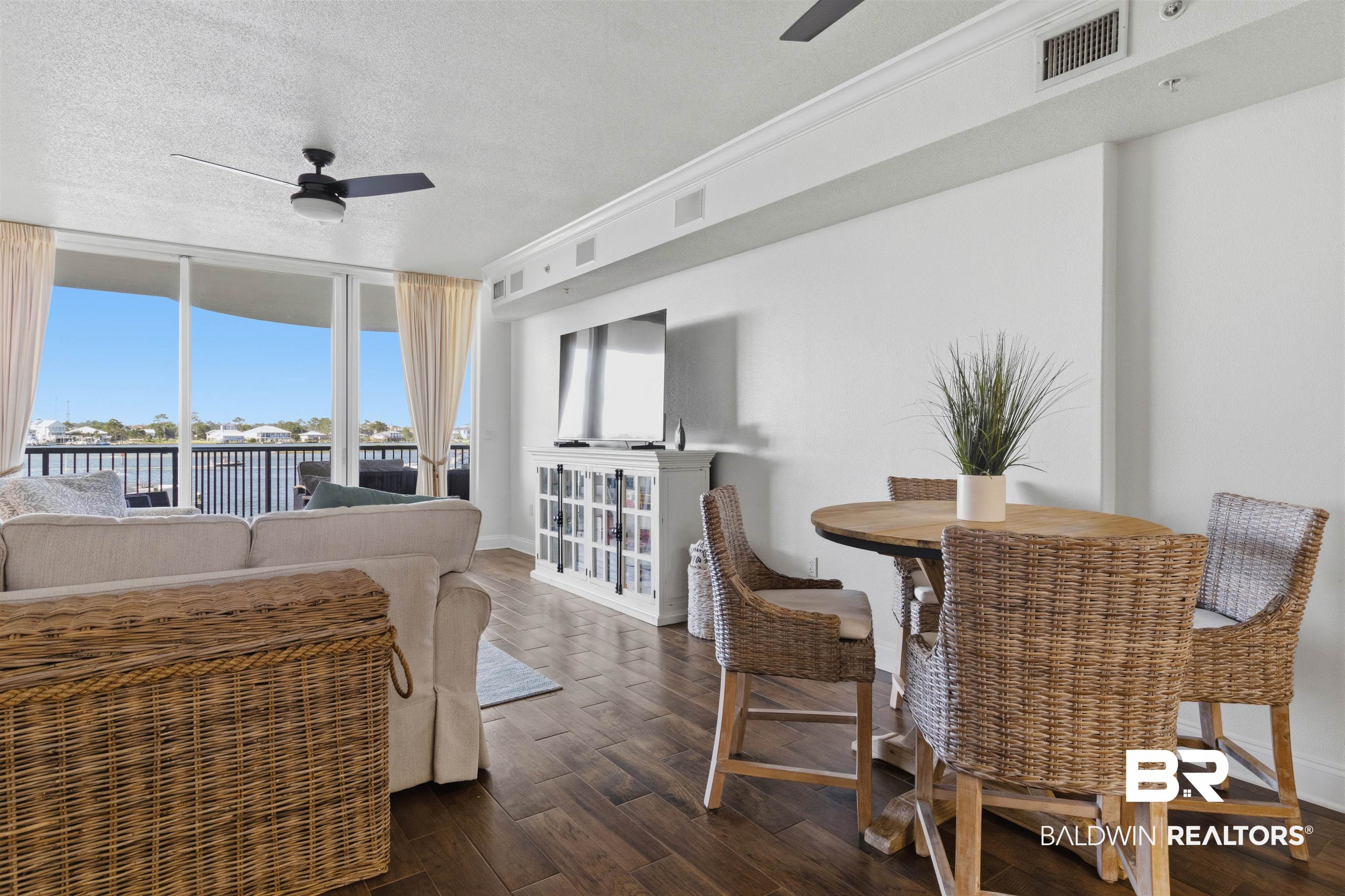3564 Bayou Road, Unit 203 Orange Beach, AL 36561 - Photo 17 of 53 Open-concept living area with wood-finish flooring, white walls, and crown molding