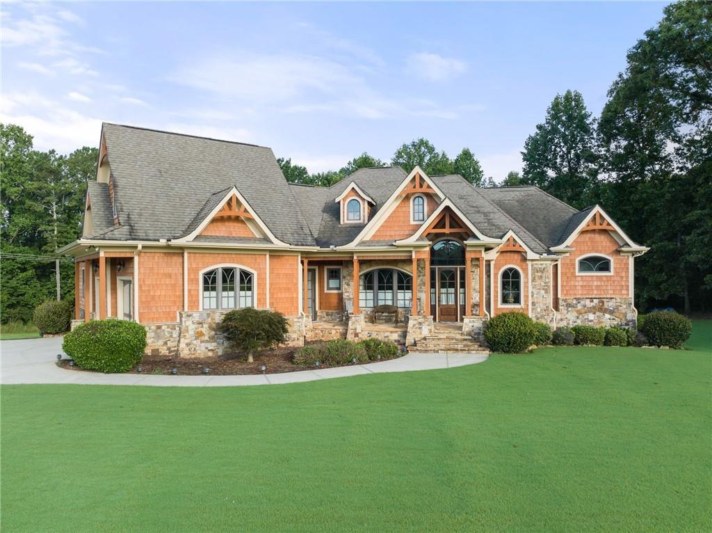 a view of house with garden and tall trees