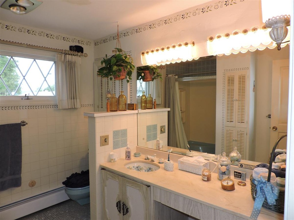 46 Point Pleasant Road Webster, MA 01570 - Photo 21 of 30 a bathroom with a sink double vanity and a mirror