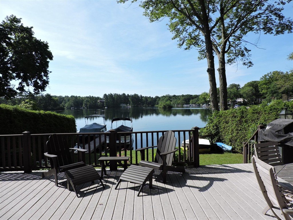 46 Point Pleasant Road Webster, MA 01570 - Photo 3 of 30 a view of a deck with table and chairs a barbeque with wooden floor and fence