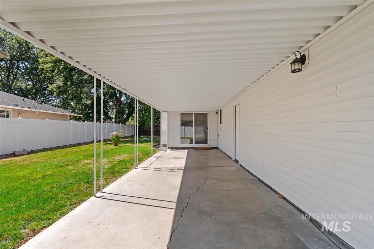2217 North Middlefield Road Boise, ID 83704 - Photo 31 of 34 Covered patio area featuring a concrete surface, white siding, and an overhead lighting fixture