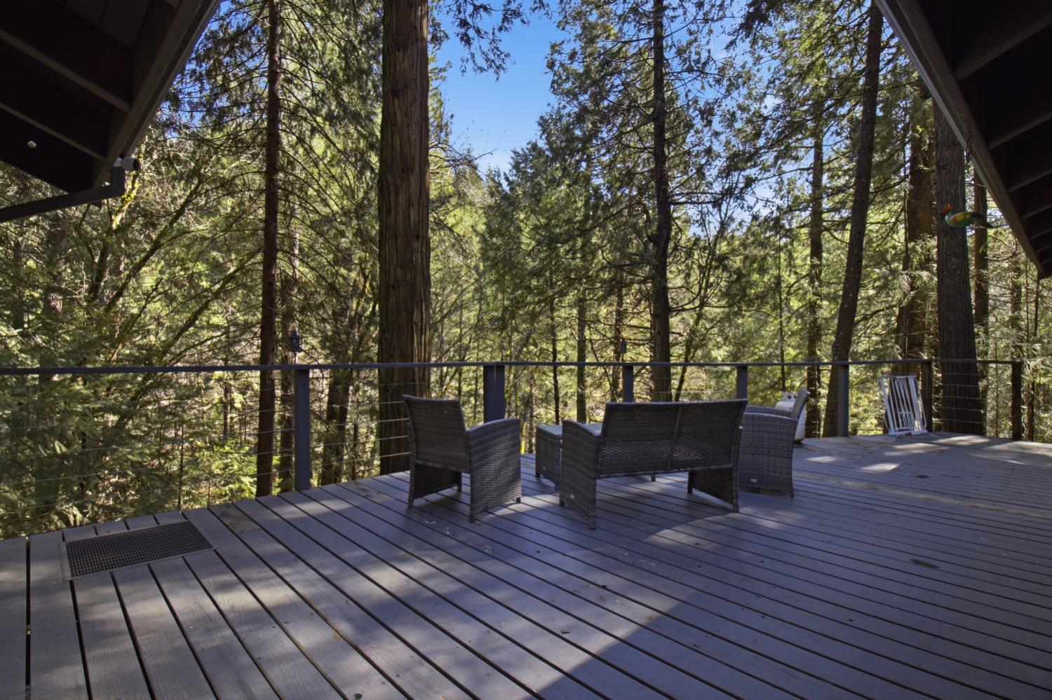 4599 Rivendale Road Placerville, CA 95667 - Photo 21 of 27 a view of deck with table and chairs and wooden floor