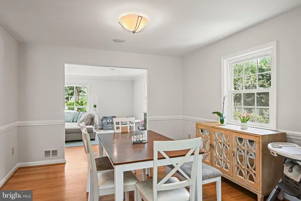 a dining room with furniture a rug and wooden floor