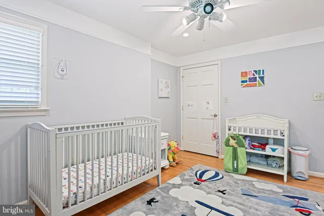 a bedroom with furniture and a baby crib