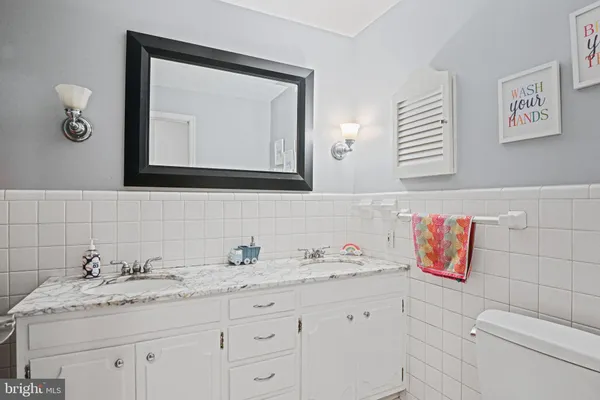 a bathroom with a sink vanity and mirror