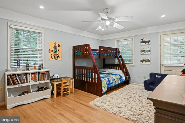 a bedroom with furniture and a wooden floor