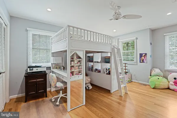 a bedroom with furniture and a wooden floor