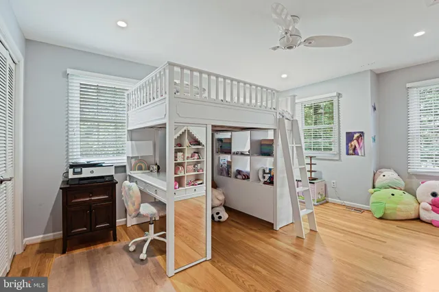 a bedroom with furniture and a wooden floor