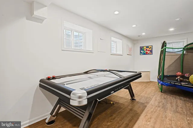 a room with table chairs and wooden floor