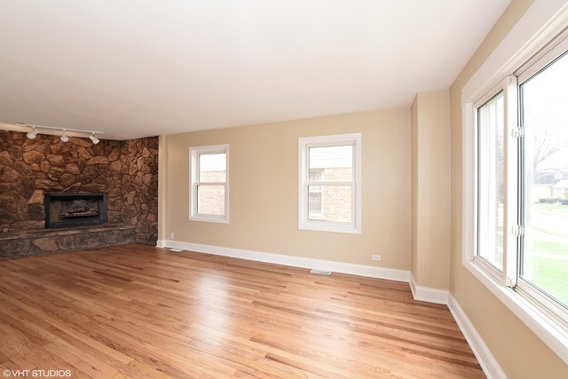 1915 Herbert Avenue Berkeley, IL 60163 - Photo 2 of 10 a view of an empty room with wooden floor and a window