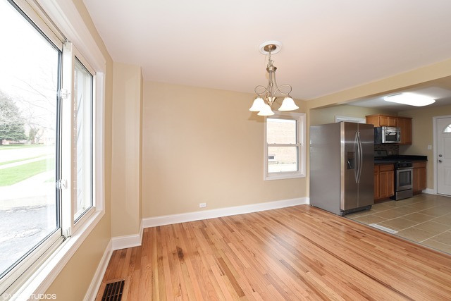 1915 Herbert Avenue Berkeley, IL 60163 - Photo 4 of 10 wooden floor in an empty room with a window
