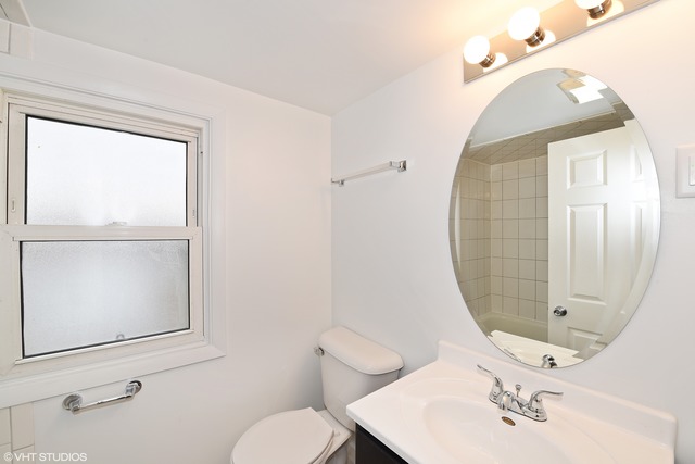 1915 Herbert Avenue Berkeley, IL 60163 - Photo 7 of 10 a bathroom with a sink mirror and toilet