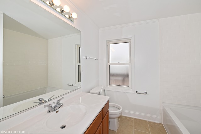 1915 Herbert Avenue Berkeley, IL 60163 - Photo 9 of 10 a bathroom with a sink a toilet and shower