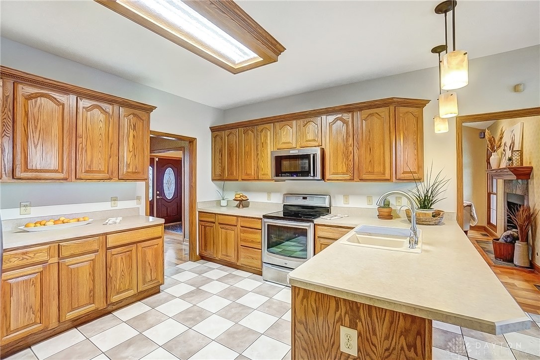 1540 Jasper Road Xenia, OH 45385 - Photo 18 of 91 This kitchen features rich wooden cabinetry complemented by a checkered floor.