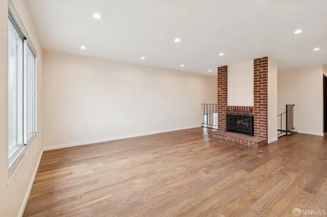 a view of kitchen with stainless steel appliances refrigerator stove dining table and chairs