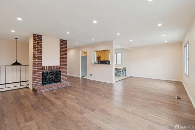 a kitchen with stainless steel appliances granite countertop a refrigerator a stove and a sink