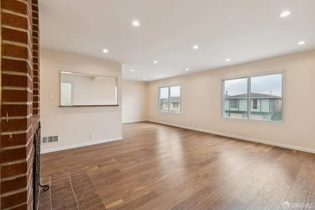 a kitchen with granite countertop a refrigerator and a stove top oven