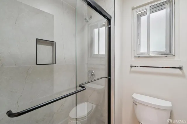 a view of an empty room and wooden floor