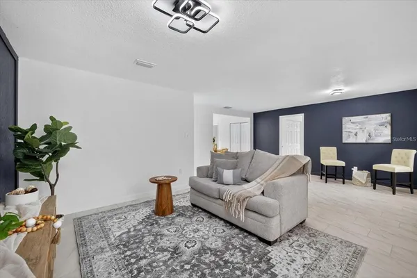 a living room with furniture and a potted plant