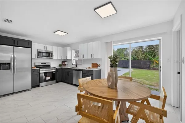 a kitchen with granite countertop a sink stainless steel appliances and cabinets