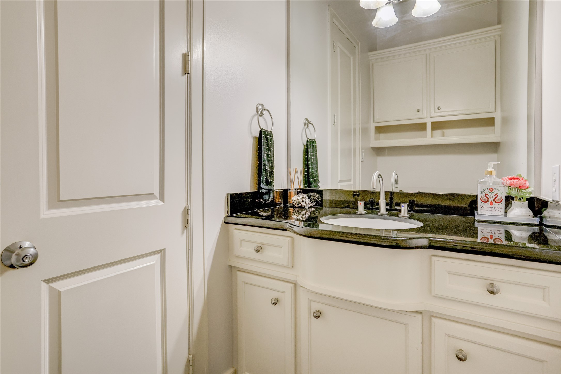 4262 Childress Street, Unit B Houston, TX 77005 - Photo 14 of 22 a sink with a mirror