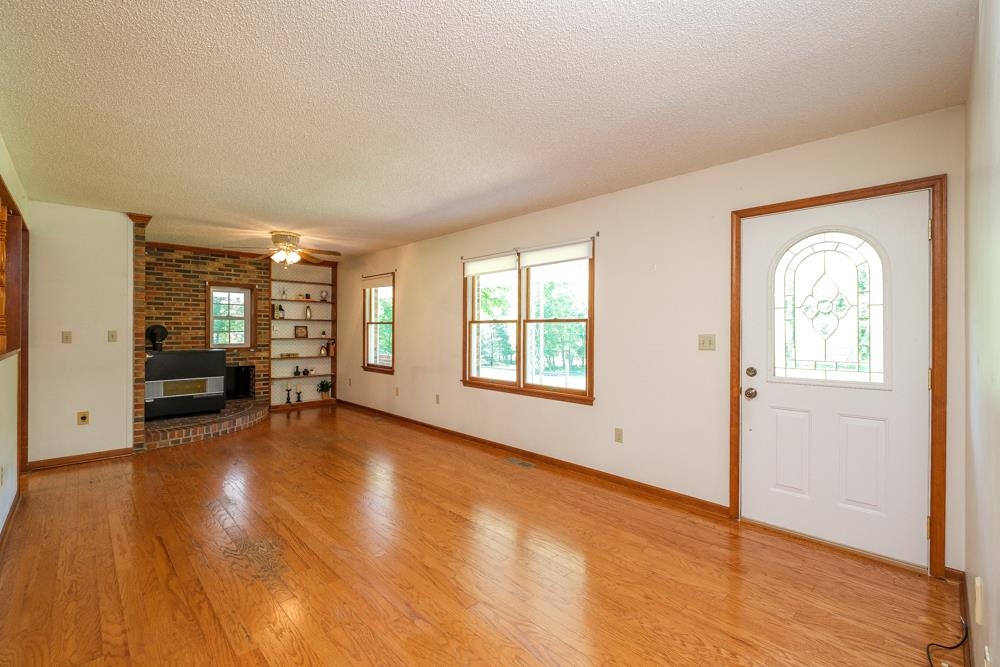 20982 Bennett Run Road Bergton, VA 22811 - Photo 14 of 54 an empty room with fireplace and windows
