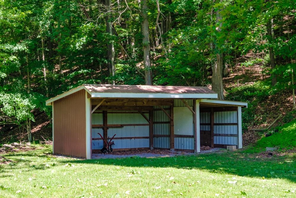 20982 Bennett Run Road Bergton, VA 22811 - Photo 45 of 54 a view of a wooden house with a yard and large tree