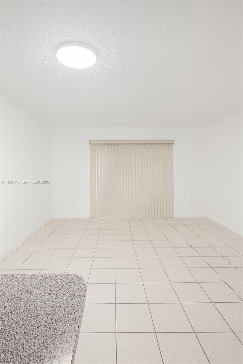 8170 Northwest 10th Street, Unit 2 Miami, FL 33126 - Photo 3 of 10 a view of an empty room and window