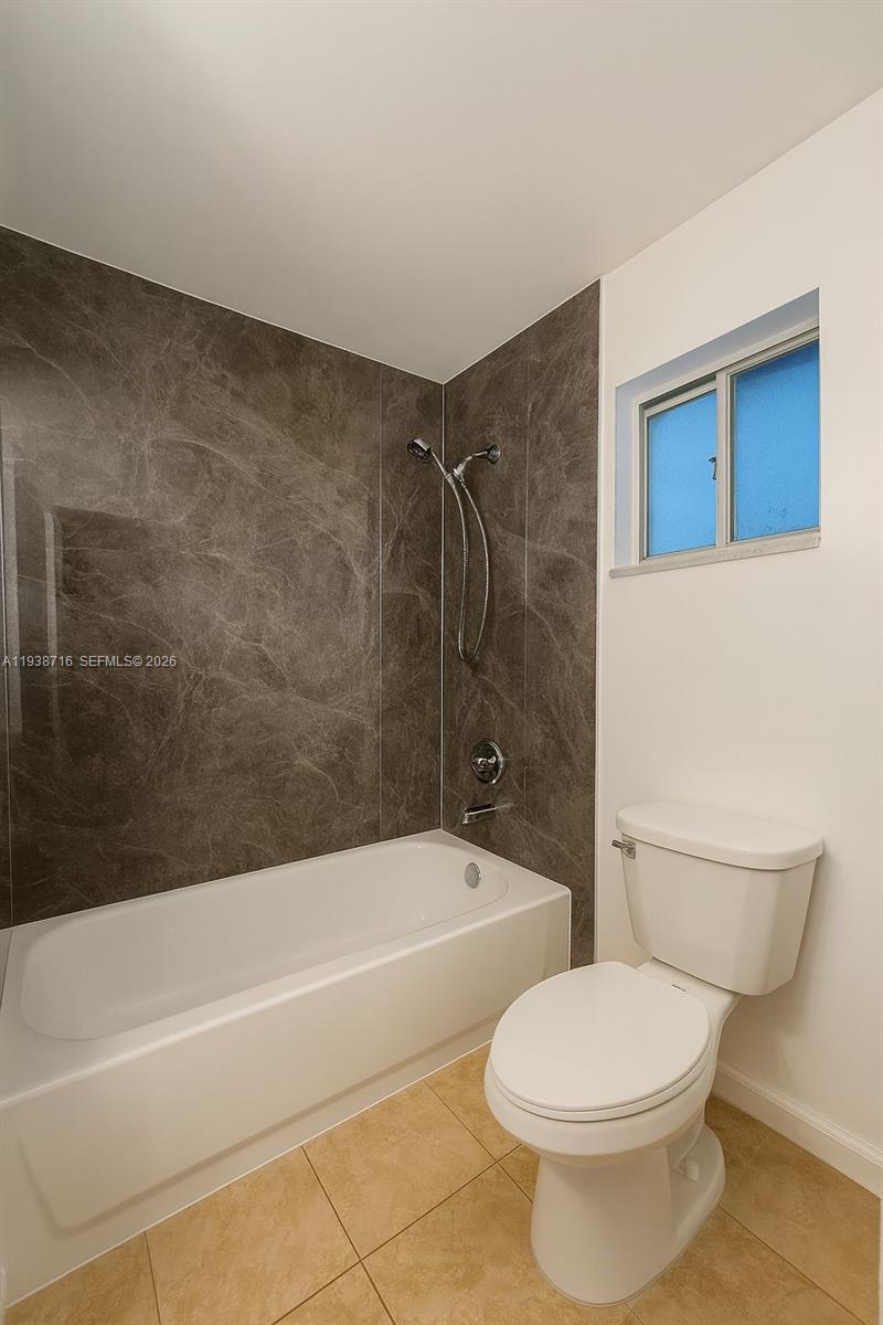 8170 Northwest 10th Street, Unit 2 Miami, FL 33126 - Photo 7 of 10 a bathroom with a toilet and a bath tub