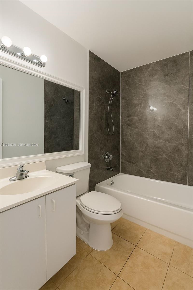 8170 Northwest 10th Street, Unit 2 Miami, FL 33126 - Photo 8 of 10 a bathroom with a sink a toilet and shower