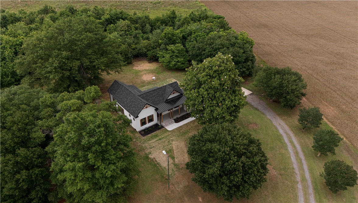 2817 Broadway Lake Road Anderson, SC 29621 - Photo 34 of 41 Nestled among verdant trees, this charming residence offers a peaceful rural retreat with an inviting front porch.