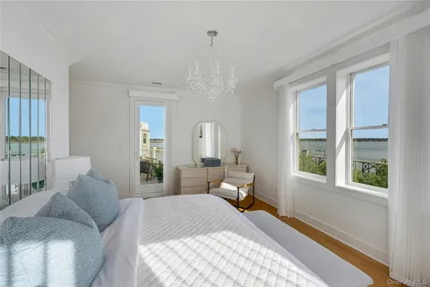 a bedroom with two beds and a chandelier
