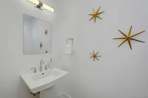 a bathroom with a double vanity sink mirror and shower