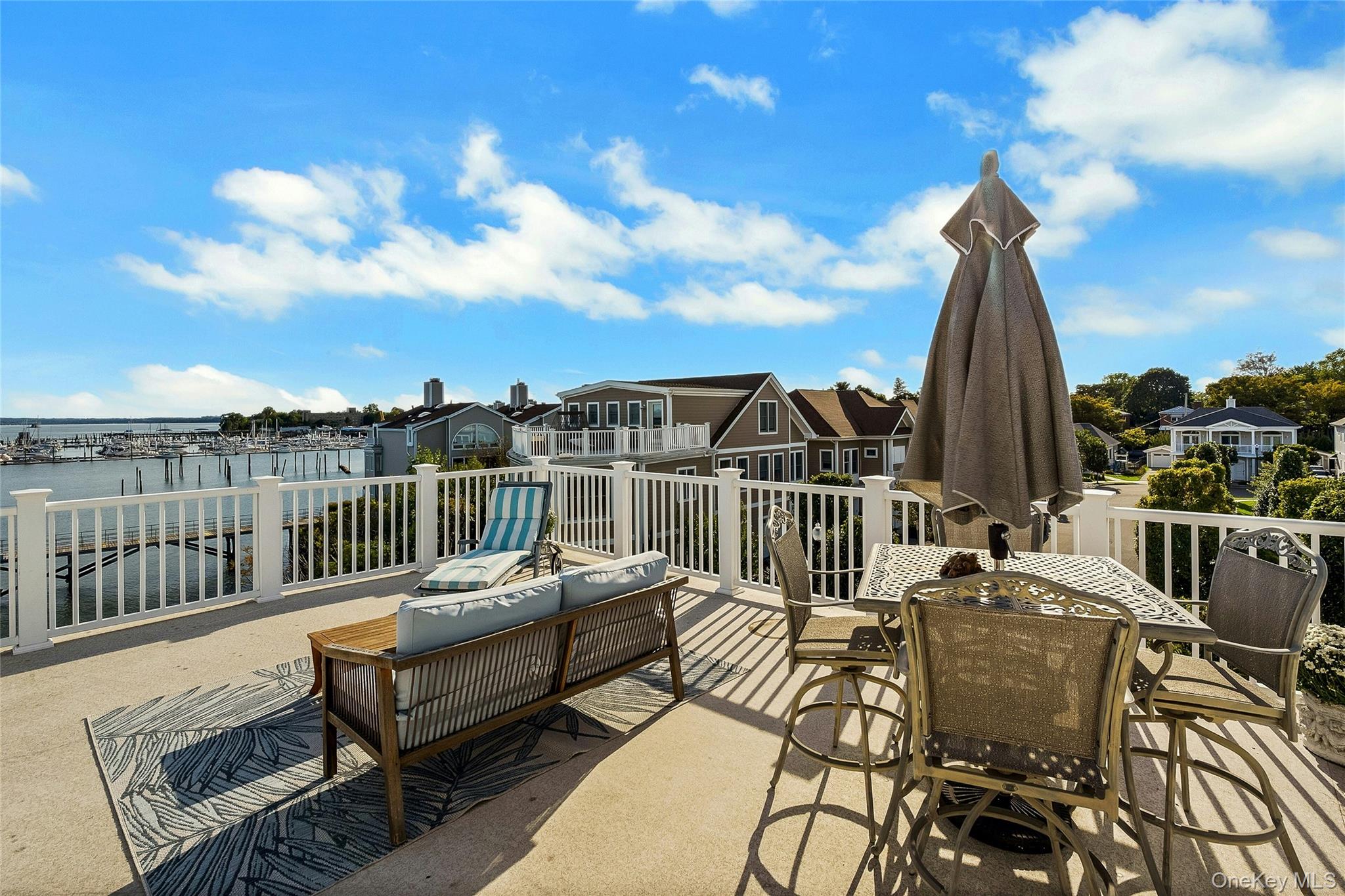 39 Island Point Bronx, NY 10464 - Photo 26 of 37 a view of a balcony with wooden floor and outdoor seating