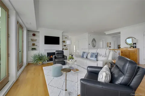 a living room with furniture and floor to ceiling windows