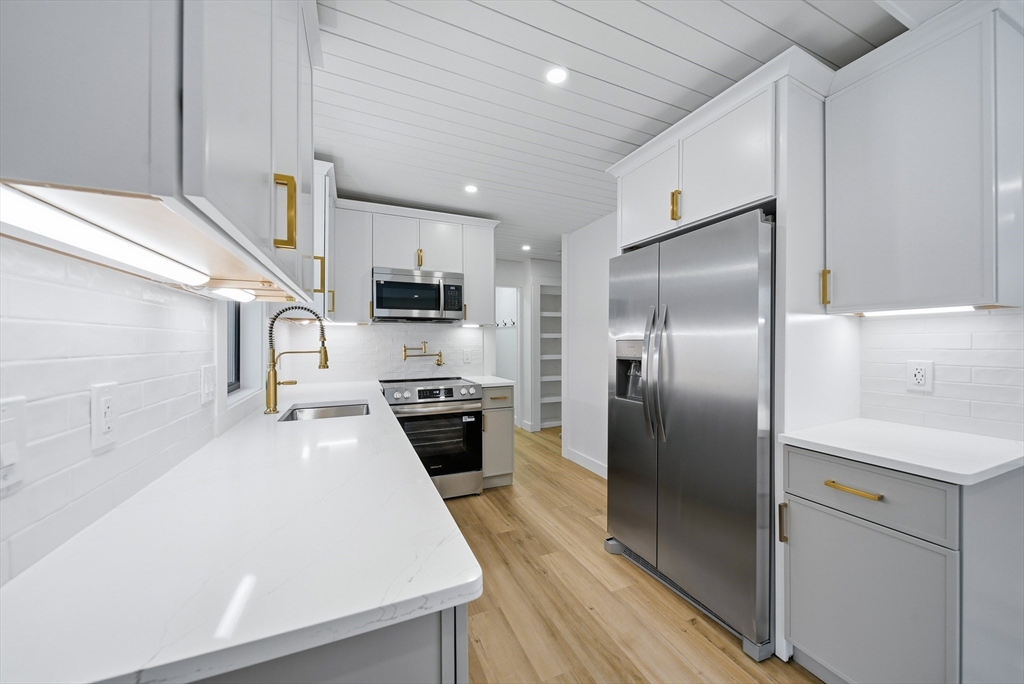 26 Rivulet Street Uxbridge, MA 01569 - Photo 11 of 41 a kitchen with stainless steel appliances a refrigerator sink and stove